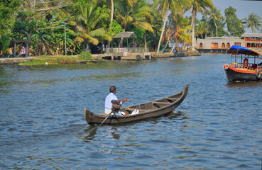 Fototapeta na wymiar A man rowing a boat on the river