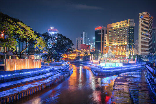 Masjid Jamek and the blue pool in the heart of city center Kuala Lumpur at night in Malaysia.