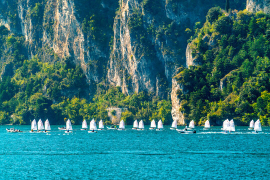 Sailing boats on the mountain lake Garda. Alps, Italy.