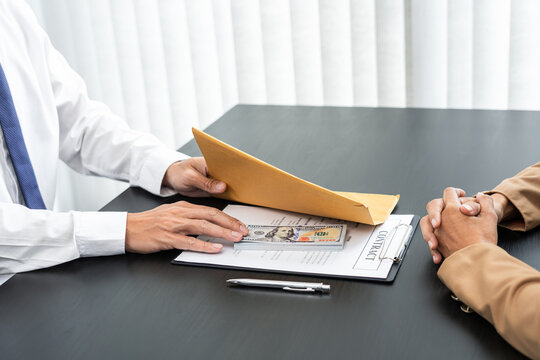 Businessmen give money to bribe partner secretly passing money, bribery and corruption concepts.