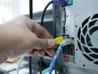 Technicians adjustment LAN cable network connected to computer.