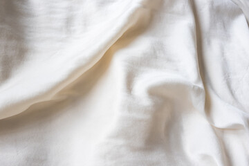 Full frame closeup of cream silk fabric - background concept