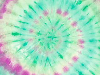 : Spiral tie dye wallpaper. Hippie tie-dye background. Tiedye backdrop. Psychedelic tie dye pattern in green purple.