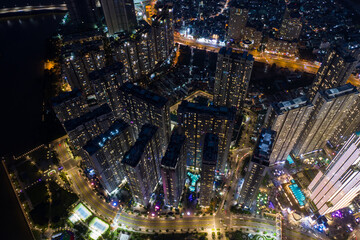 Aerial urban colorful sunrise panorama with high rise building disappearing into the clouds, city center skyline and suburban sprawl