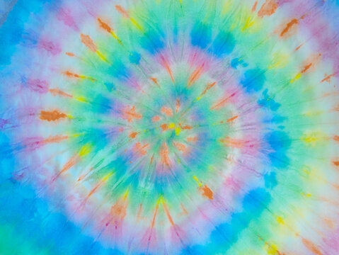 Spiral tie dye wallpaper. Hippie tie-dye background. Tiedye backdrop. Psychedelic tie dye pattern in