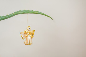 Straw Christmas ornament on aloe branch. Eco concept.