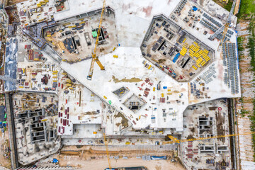 Fototapeta premium large construction site. monolithic frame construction of the building. construction site background. aerial top view