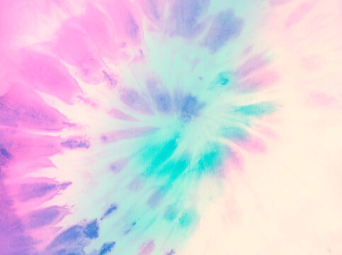 Swirl tie dye background. Hippie spiral tie-dye wallpaper backdrop. Tiedye in pastel pink and cyan.