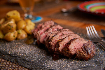 Grilled sliced beef angus with baked potatoes