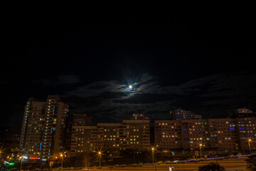 Night view on the buildings of Vladivostok with a full moon shining above 