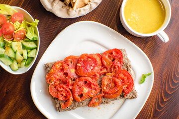 Arabic kebab spicy with tomato on top in Turkish on the wood background