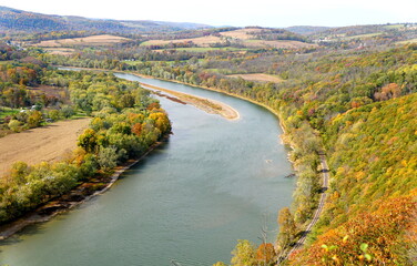 The aerial view of the Susquehanna River surrounded by striking color of fall foliage near Wyalusing, Pennsylvania, U.S