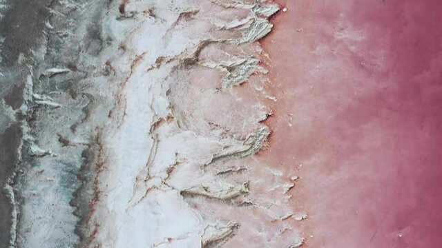 Aerial view of rare and unique pink salt lake shores.