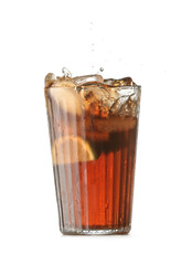 Glass of tasty Cuba Libre cocktail with splash on white background