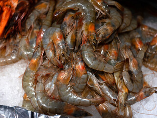 High resolution shrimp in their shells on ice in a fish market