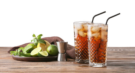Glasses of tasty Cuba Libre cocktail on table against white background