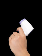 Hand holding infrared thermometer in front of black background
