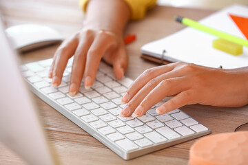 African-American woman working on computer at home, closeup