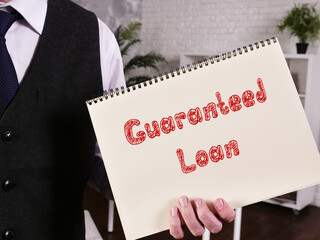 Financial concept about Guaranteed Loan with phrase on the sheet.