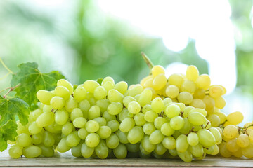 Ripe grapes on table outdoors