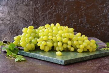 Ripe green grapes on table
