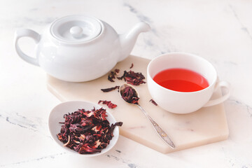 Composition with hot hibiscus tea on table