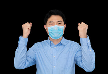 Man in mask standing in front of black background doing cheer with both hands