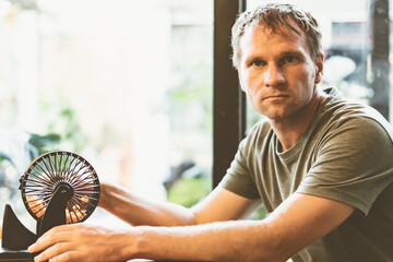Young man hold lotto sphere spins small balls, table loto game as symbol of future problem life crisis choice. Look at camera face invented idea intrigue sly smile grimace. Real skin