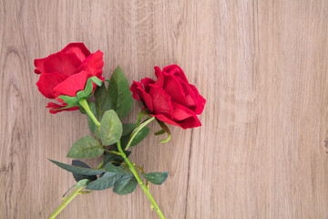 Two red roses on the table