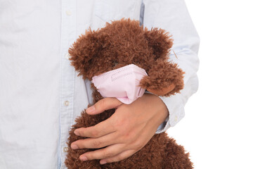 Valentine's day man holding a soft toy wearing a mask in his hand