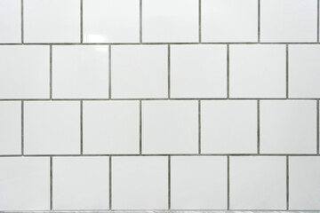 white classic ceramic tiles on the wall in the bathroom, brick tiles, background