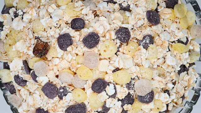 top view glass bowl of mixed oatmeal and maize and dark grains and red jujube and coix seed rotating
