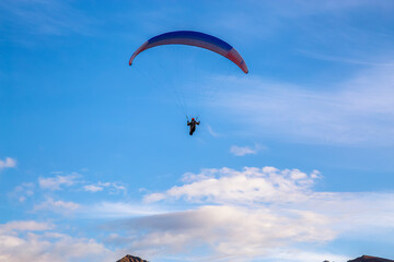 Paraglider flying Up High surrounded by Clouds in Canadian Nature. Taken in Tombstone Territorial Park, Yukon, Canada.