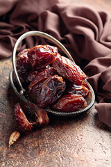 Dried sweet dates on an old brown table.
