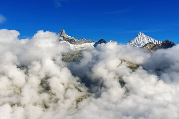 Fototapeta na wymiar Beautiful Swiss Alps landscape with mountain in clouds view in summer, Zermatt, Switzerland 