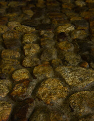 Close-Up of Natural Stone Wall Texture with Rough Surface and Irregular Pattern Background.