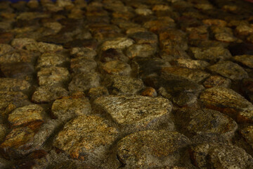 Close-Up of Natural Stone Wall Texture with Rough Surface and Irregular Pattern Background.