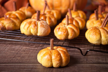 Pumpkin buns on the baking rack. Autumn concept.
