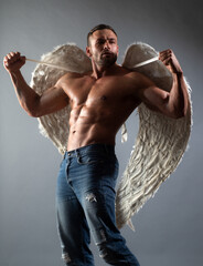 Sexy male bare torso. Handsome masculine man with angels wings.