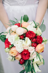 bride holding bouquet of roses