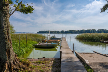A floating jetty and boats in a lake. Picture from Ringsjon, Scania county, Sweden