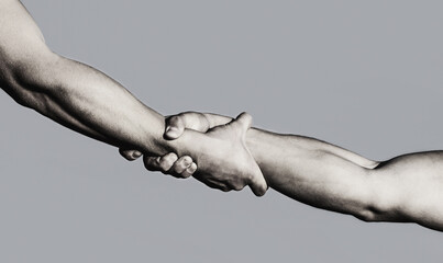 Hands of on blue sky background. Helping hand concept and international day of peace, support. Two hands, helping arm of a friend, teamwork