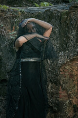 girl in black for halloween with a witch looks