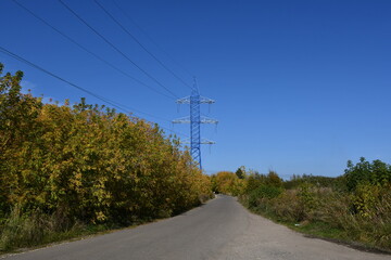 High-voltage tower and wires along a rural road