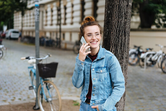 Cute grinning happy young woman on a mobile