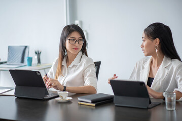 Two young asian woman working together at office modern.