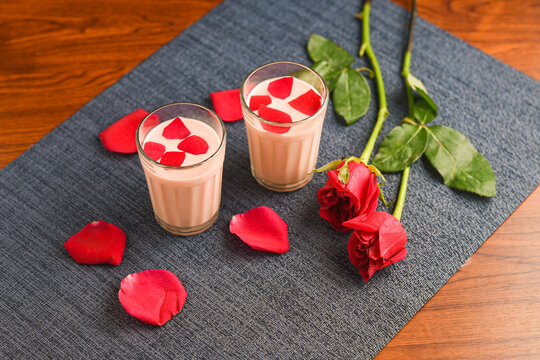 Rose milk , Rose shake , Gulab Shake with rose petals Indian valentines day drink with heart shaped red rose flowers Kerala.  strawberry milk shake or Pink Tea , Gulabi Chai refreshment Kashmir India.