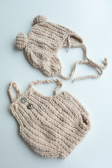 Fototapeta premium Various colors and types of cotton clothing, knitted newborn clothes and newborn hats on a white background.