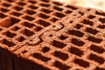 joint of two red perforated bricks close up. construction material