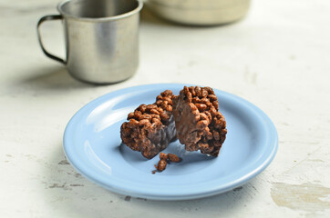 Chocolate bar on a plate with coffee